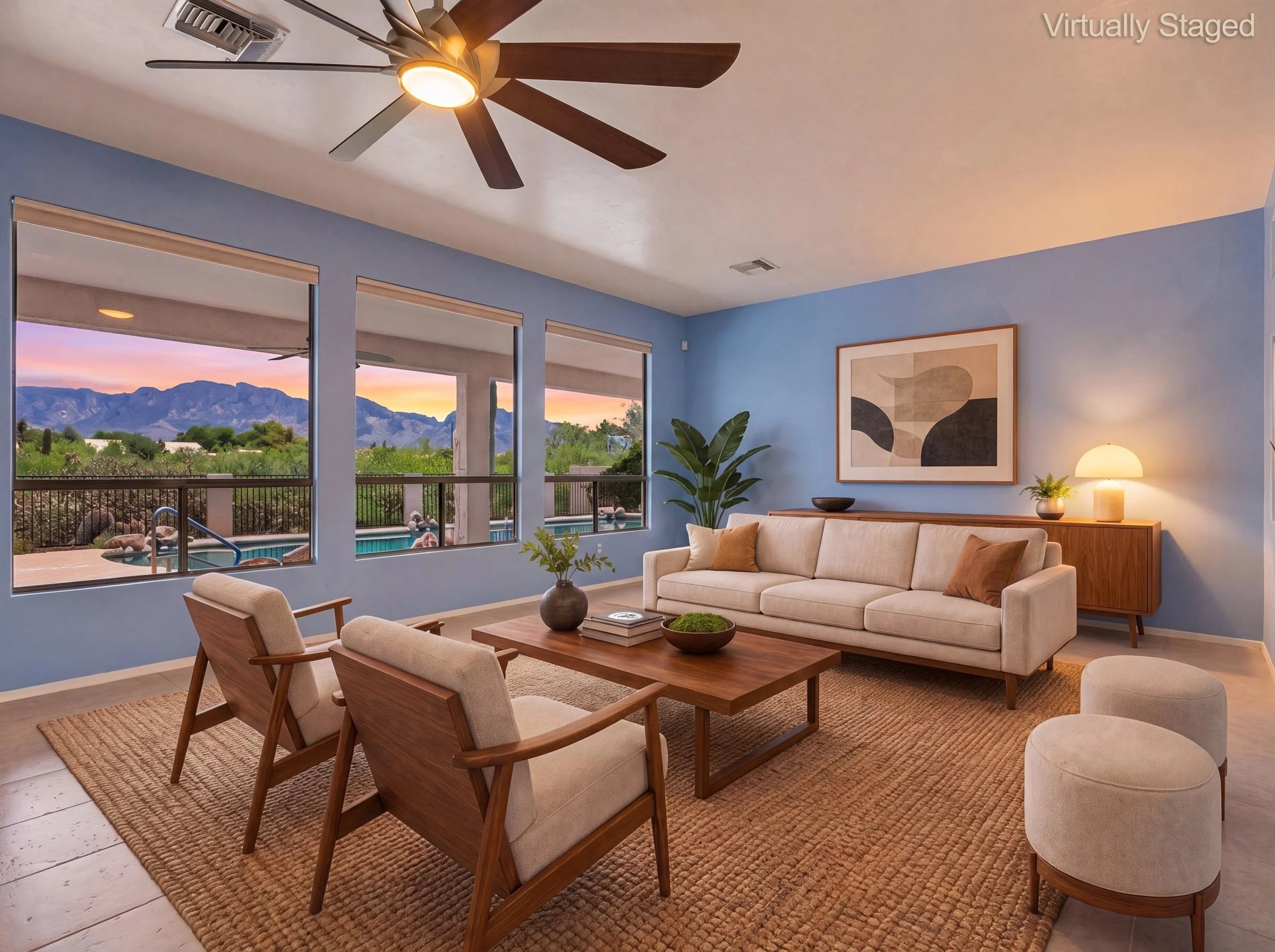 Virtually staged living room with picture windows facing the Catalina Mountains at sunset